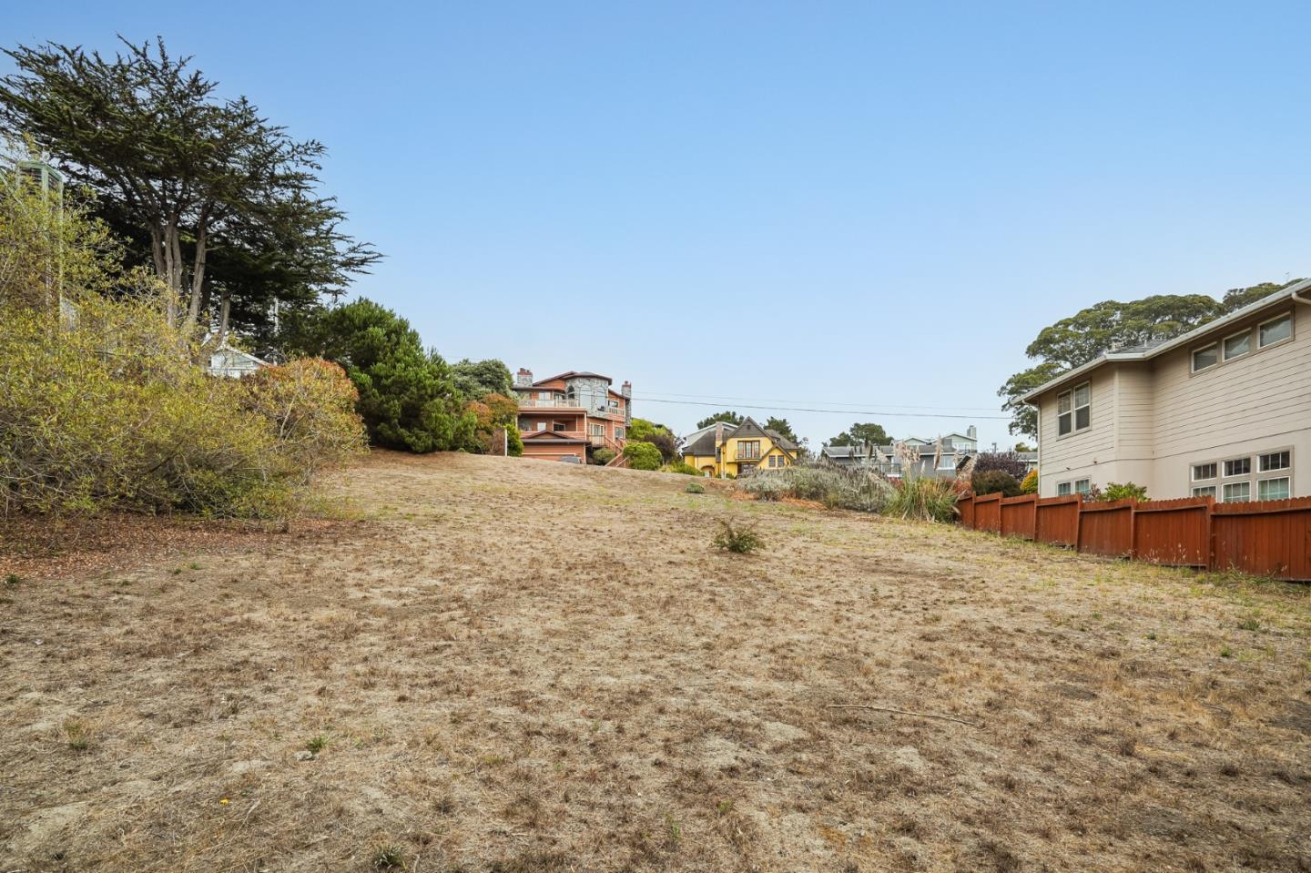0 Ave Granada Half Moon Bay, CA 94019 - Photo 22 of 26 a view of a yard with an house and wooden fence