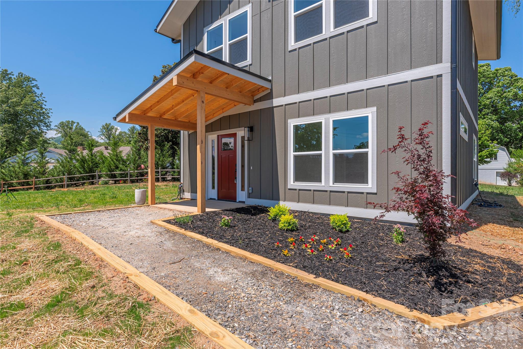 32 Oak Hill Road Candler, NC 28715 - Photo 4 of 29 a front view of a house with garden