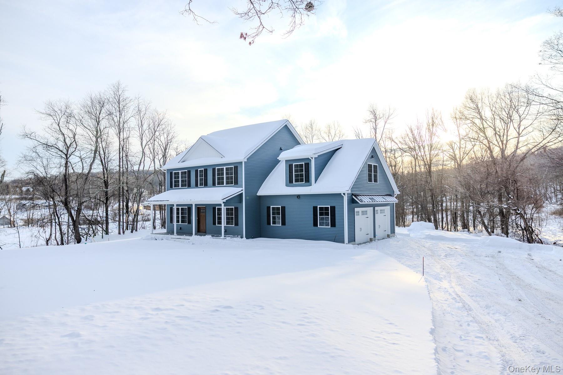a view of a house with a yard covered in snow
