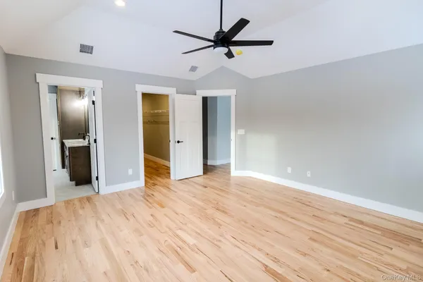 an empty room with closet and mirror