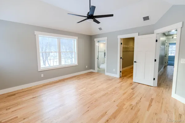 a large white kitchen with a large window