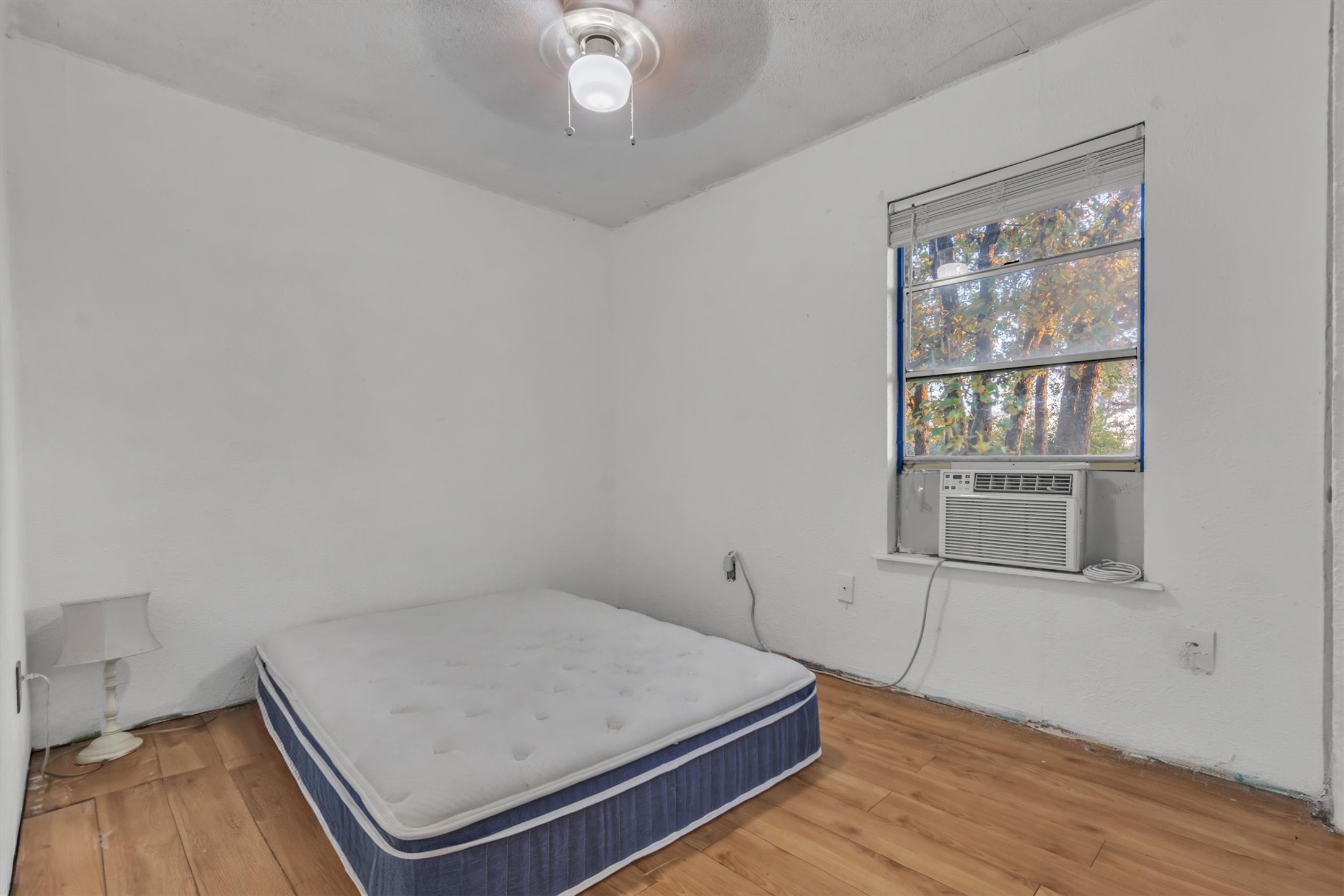 149 Wayside Drive Elgin, TX 78621 - Photo 13 of 24 Bedroom featuring a ceiling fan, light wood-type flooring, and cooling unit