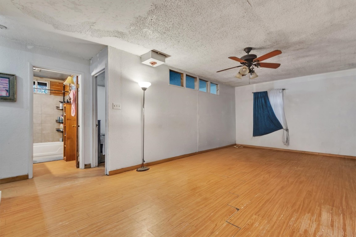 146 Wayside Drive Elgin, TX 78621 - Photo 5 of 24 Spare room featuring light wood-style floors, a ceiling fan, and a textured ceiling
