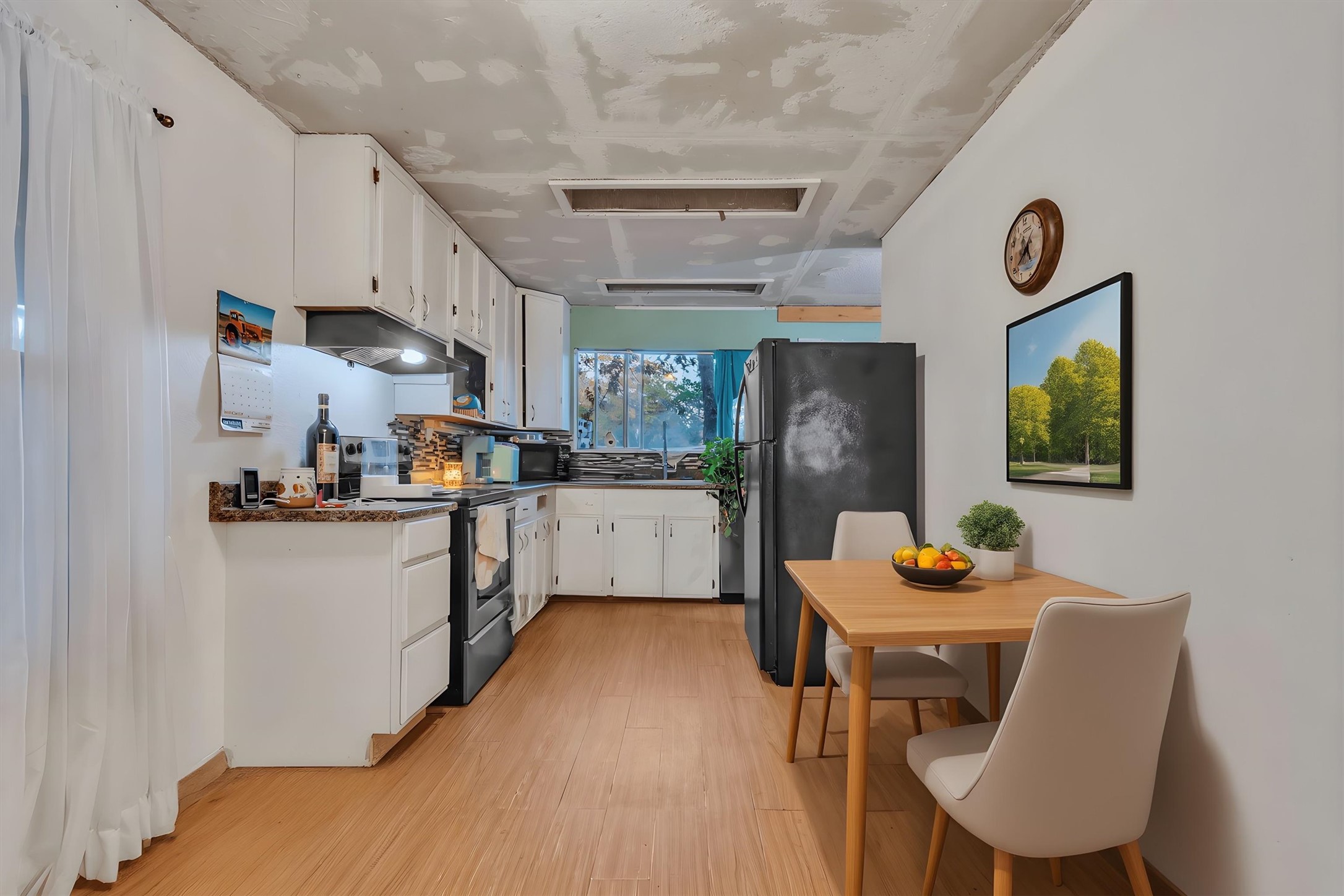 149 Wayside Drive Elgin, TX 78621 - Photo 7 of 24 Kitchen featuring freestanding refrigerator, white cabinetry, stainless steel electric range oven, and light wood-style flooring
