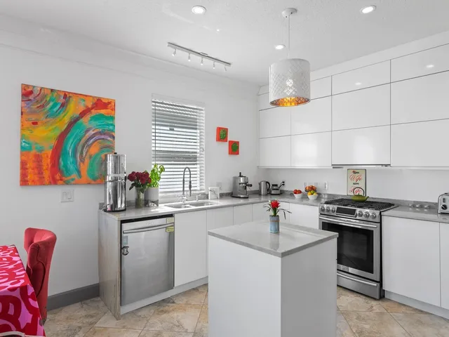 a kitchen with cabinets a sink and appliances