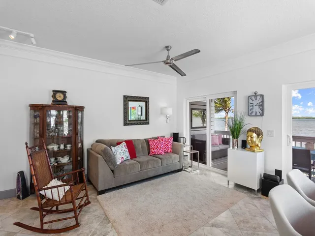 a living room with furniture and painting on the wall