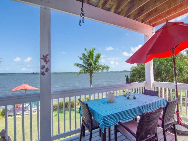 a table and chairs in patio of a house