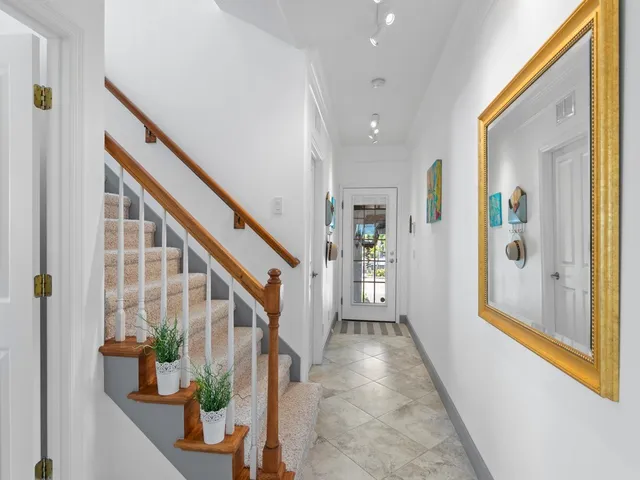 a view of an entryway with wooden floor and windows