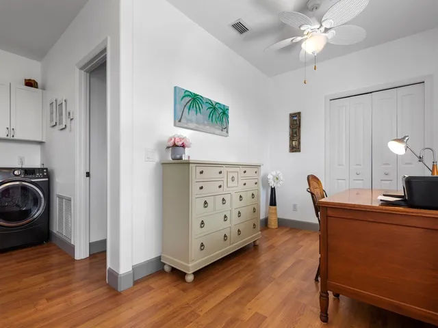 a view of a workspace with furniture and wooden floor