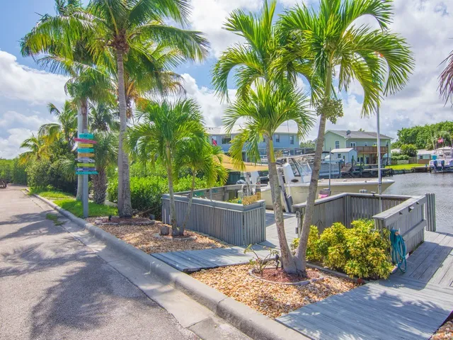 a front view of a house with swimming pool and sitting area