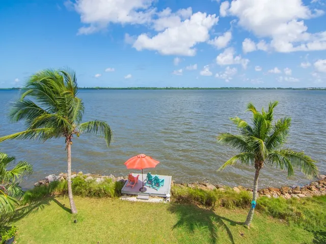 a view of an ocean with a house in the background