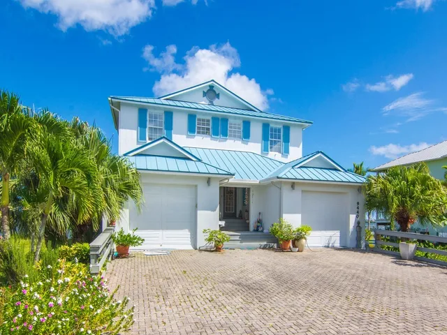a front view of a house with a garden and porch