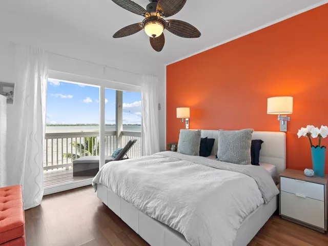 a bedroom with a large bed and a large window