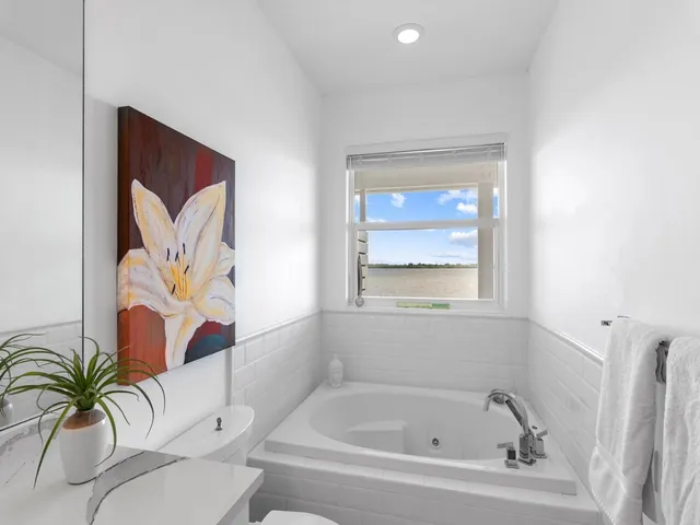 a bathroom with a bathtub and a window