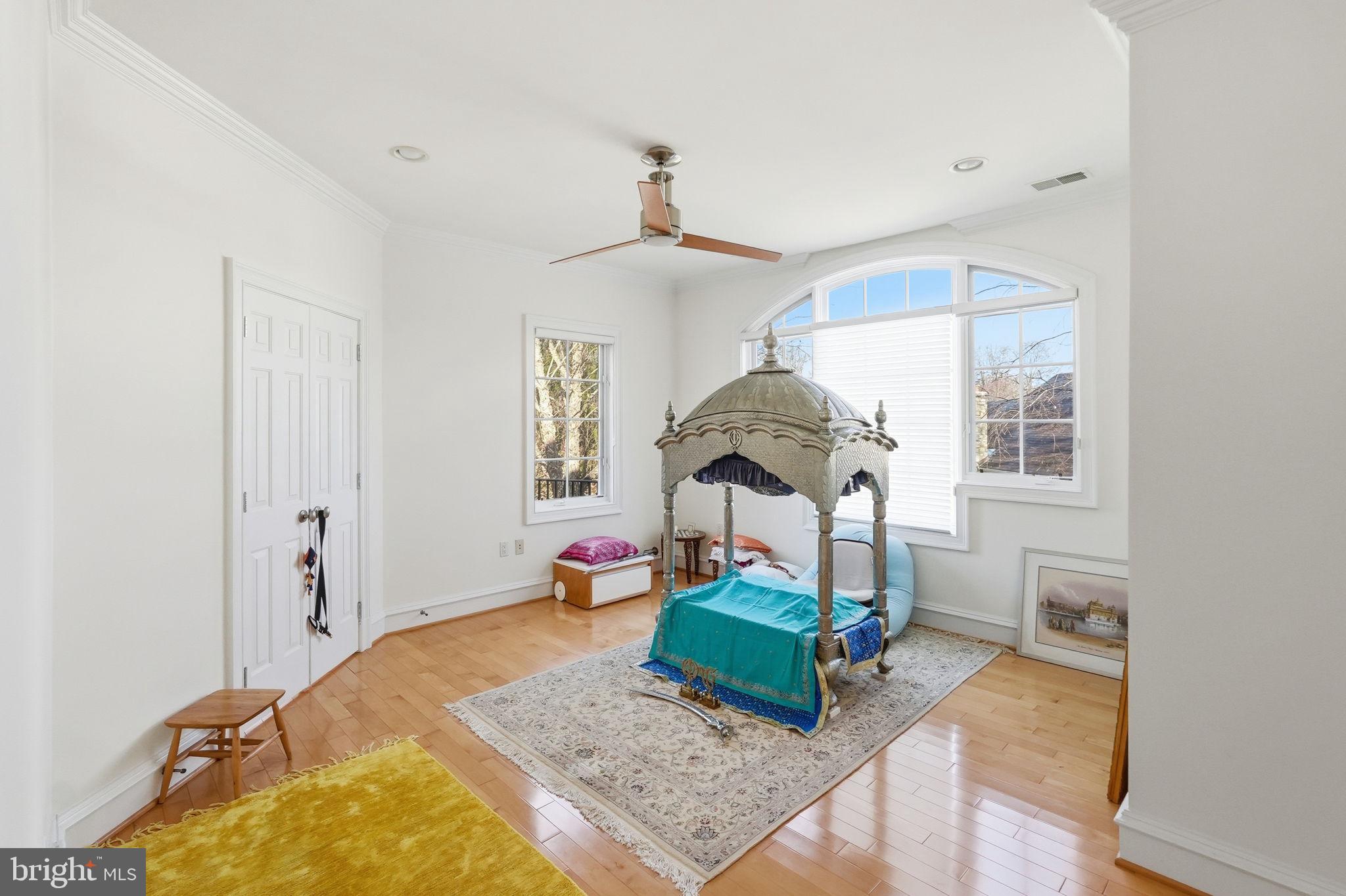 8537 Rapley Preserve Circle Potomac, MD 20854 - Photo 26 of 40 a bedroom with a bed a chandelier and dresser