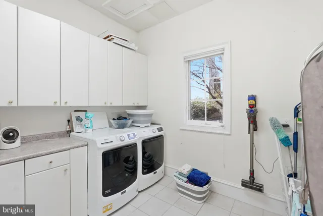 a view of an empty room with wooden floor and a fireplace