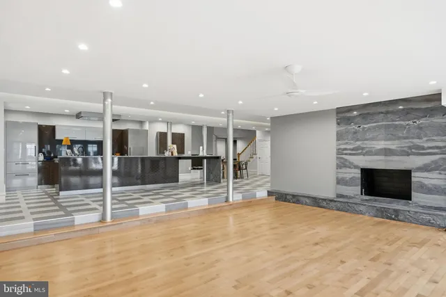 a kitchen with stainless steel appliances kitchen island granite countertop a sink and cabinets