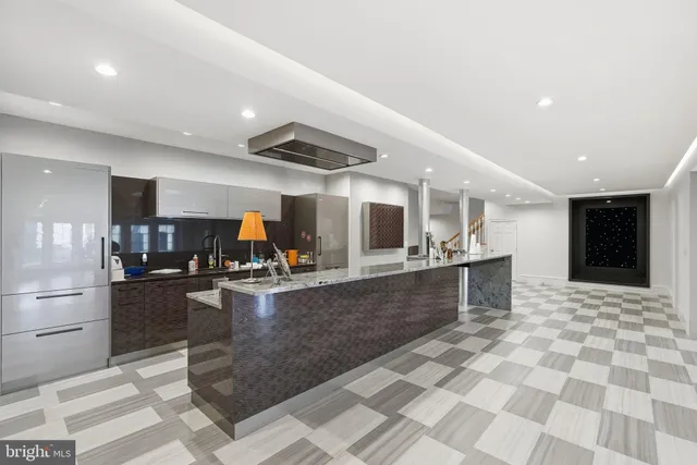 a large kitchen with a table and chairs in it