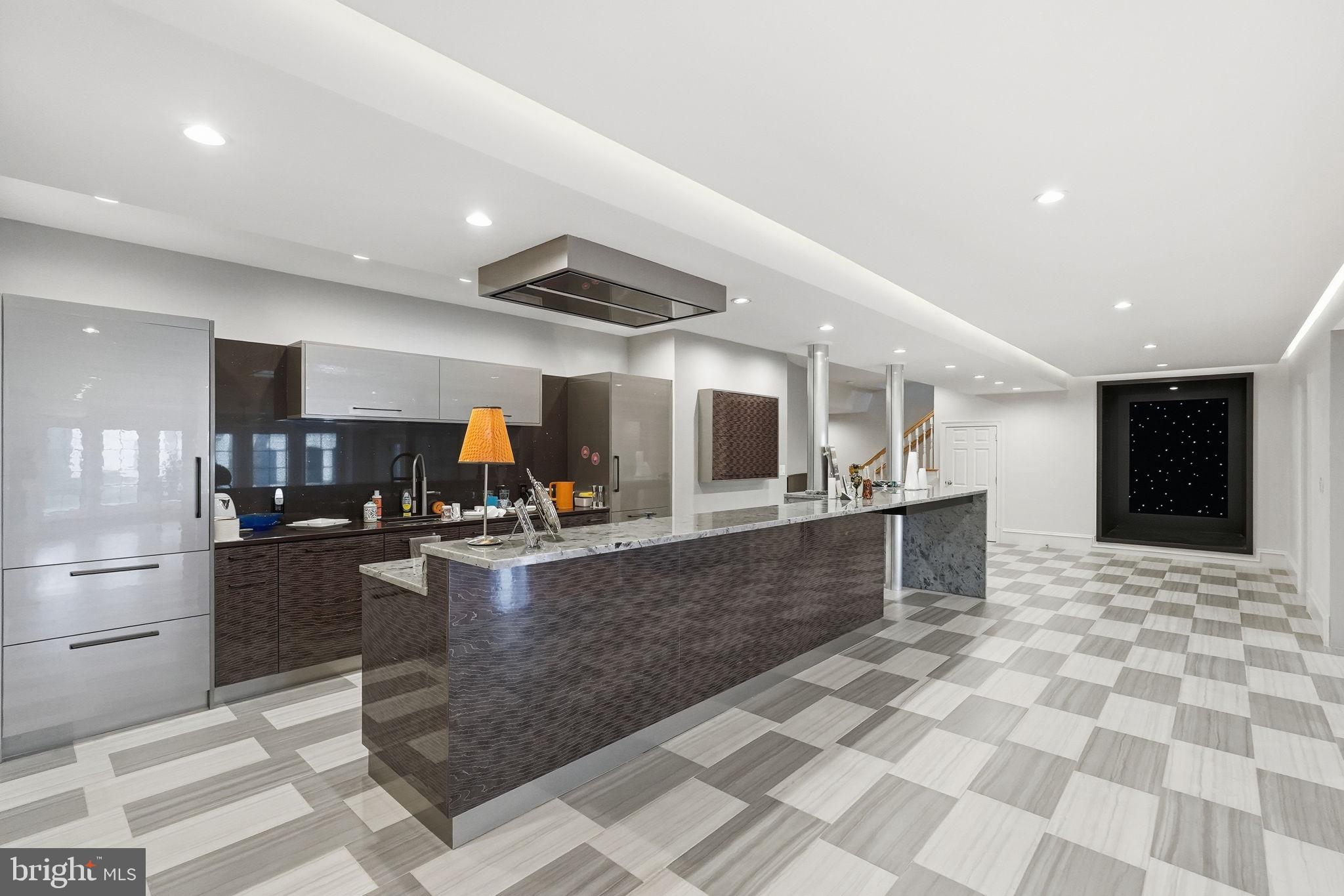 8537 Rapley Preserve Circle Potomac, MD 20854 - Photo 33 of 40 a kitchen with stainless steel appliances kitchen island granite countertop a sink and cabinets