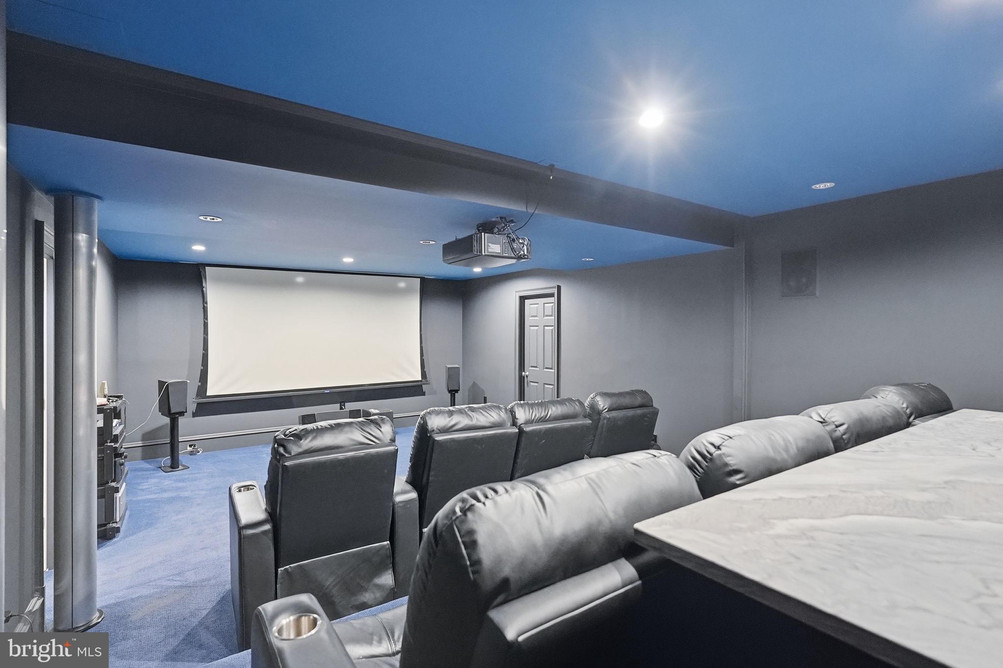 8537 Rapley Preserve Circle Potomac, MD 20854 - Photo 36 of 40 a media room with lots of chairs and a projector screen