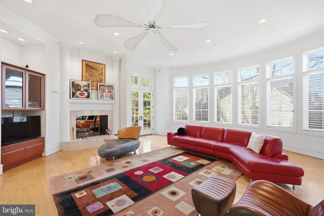 a bedroom with furniture and a large window