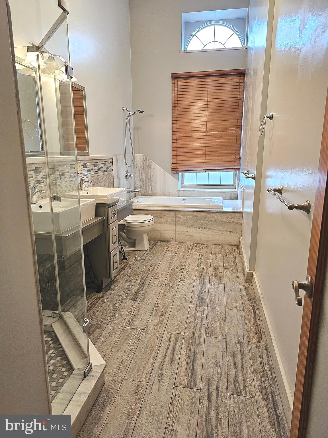 1268 South 26th Street, Unit 3E Philadelphia, PA 19146 - Photo 6 of 13 a bathroom with a sink a toilet a mirror and bathtub