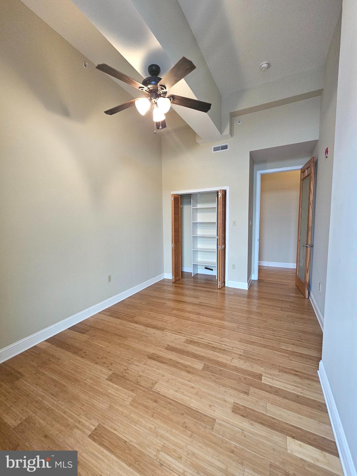 1268 South 26th Street, Unit 3E Philadelphia, PA 19146 - Photo 8 of 13 a view of an empty room with wooden floor and a ceiling fan