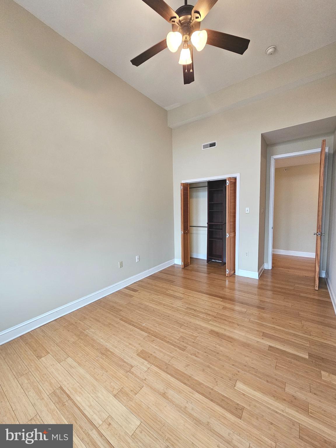 1268 South 26th Street, Unit 3E Philadelphia, PA 19146 - Photo 10 of 13 an empty room with wooden floor and windows