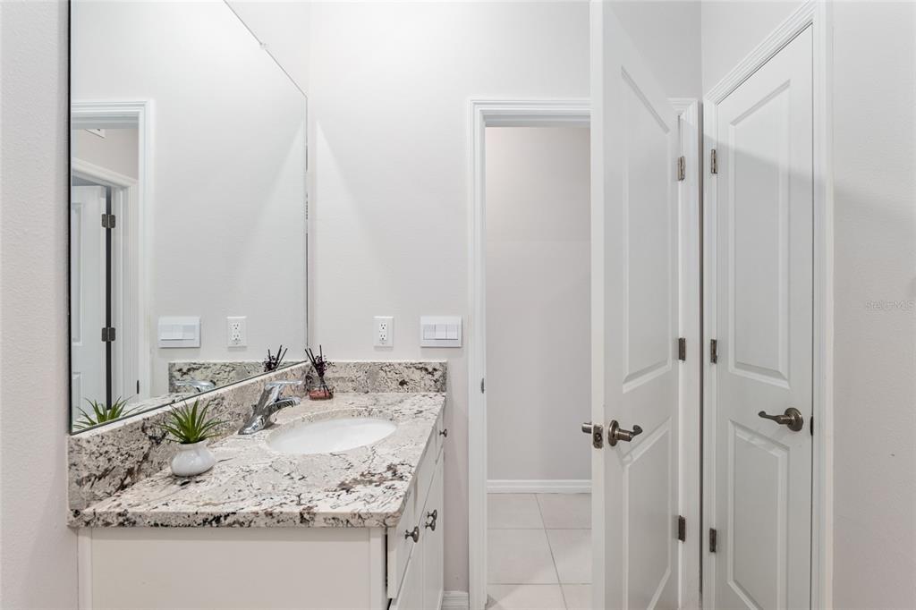 6243 Southwest 89th St Road Ocala, FL 34476 - Photo 12 of 57 a bathroom with a granite countertop sink and a mirror