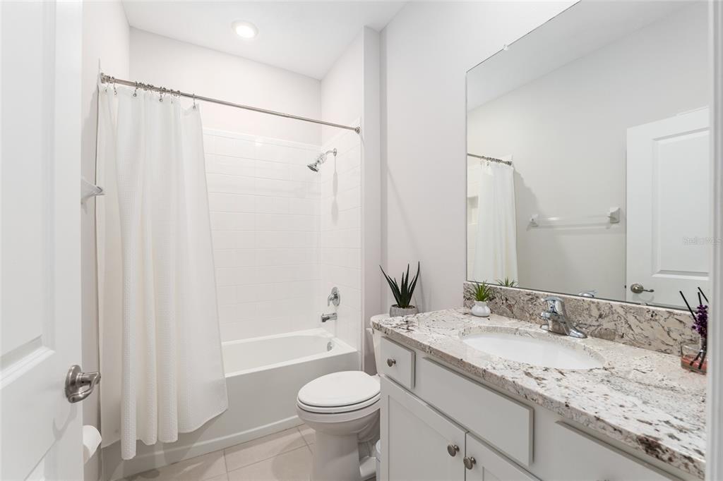 6243 Southwest 89th St Road Ocala, FL 34476 - Photo 13 of 57 a bathroom with a granite countertop sink toilet and shower