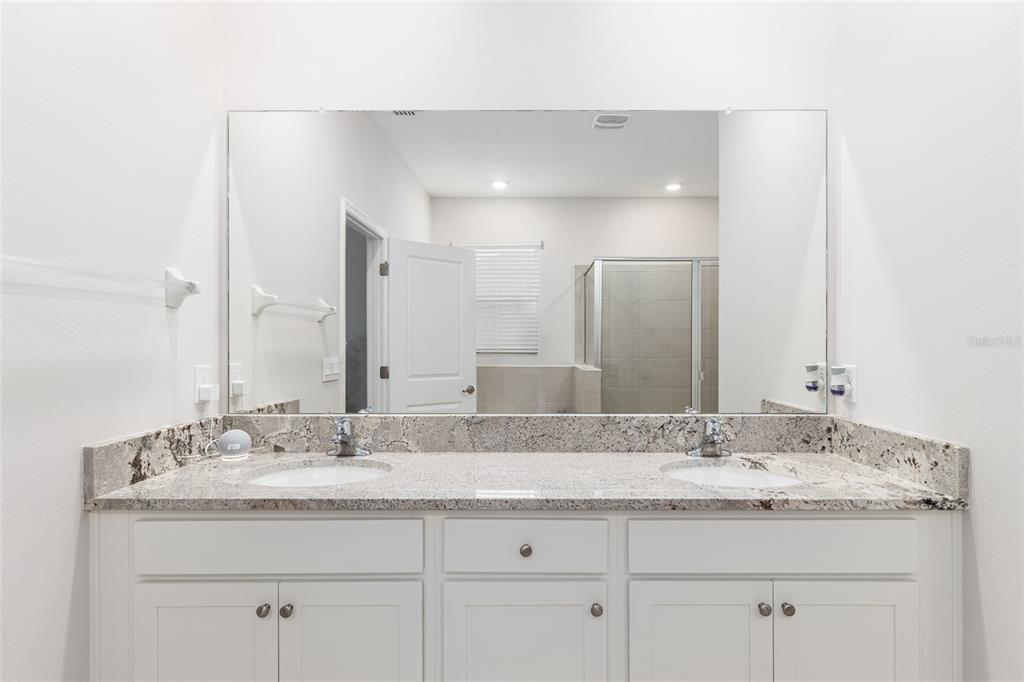 6243 Southwest 89th St Road Ocala, FL 34476 - Photo 18 of 57 a bathroom with a granite countertop sink a mirror and double