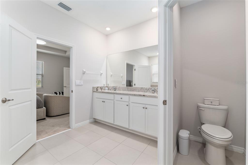 6243 Southwest 89th St Road Ocala, FL 34476 - Photo 22 of 57 a bathroom with a toilet sink and mirror