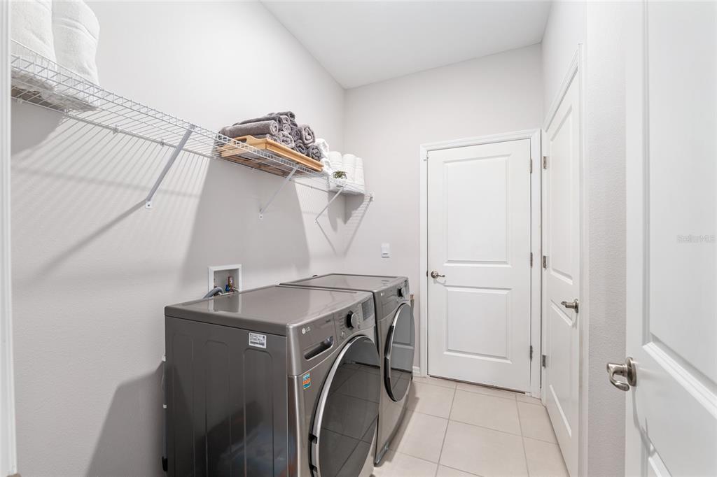 6243 Southwest 89th St Road Ocala, FL 34476 - Photo 27 of 57 a utility room with cabinets washer and dryer