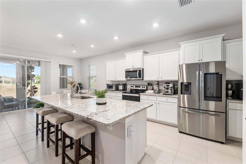 6243 Southwest 89th St Road Ocala, FL 34476 - Photo 36 of 57 a kitchen with appliances a sink and cabinets