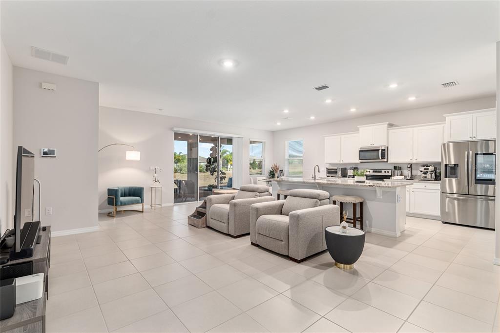 6243 Southwest 89th St Road Ocala, FL 34476 - Photo 43 of 57 a large living room with stainless steel appliances kitchen island granite countertop lots of white stainless steel appliances