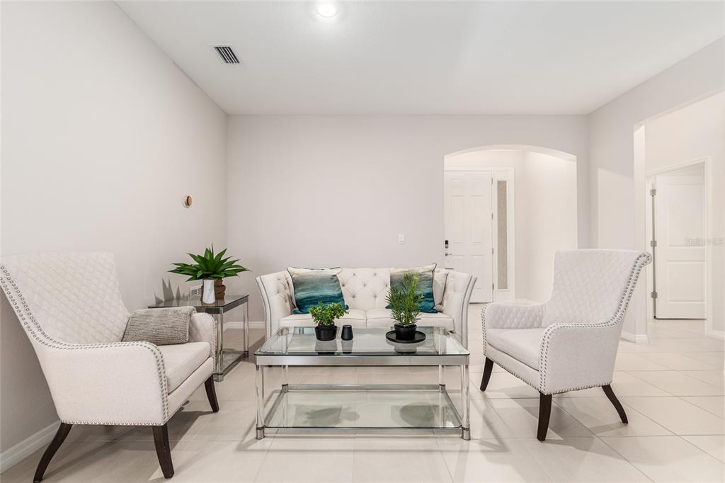 6243 Southwest 89th St Road Ocala, FL 34476 - Photo 46 of 57 a living room with furniture and a potted plant