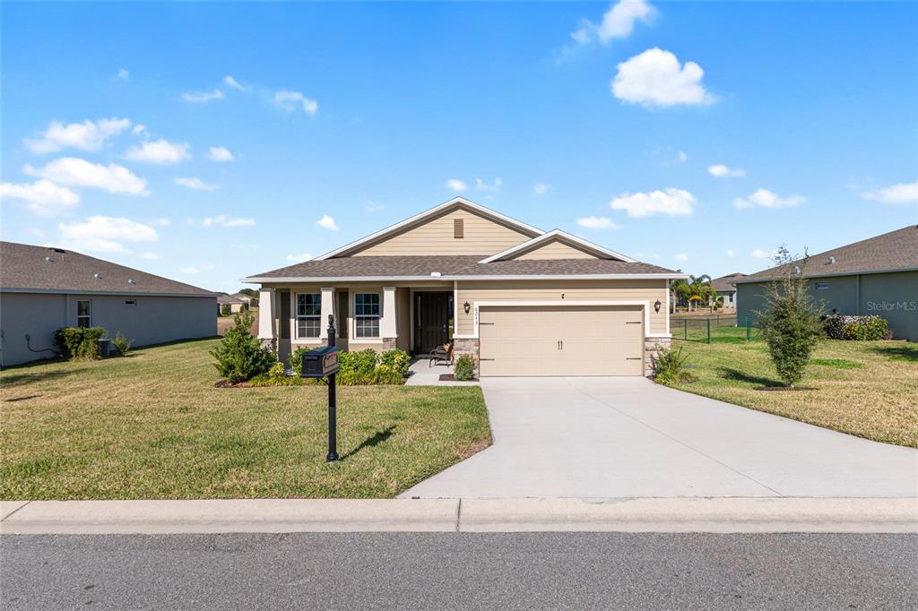 6243 Southwest 89th St Road Ocala, FL 34476 - Photo 47 of 57 a front view of a house with a yard and garage