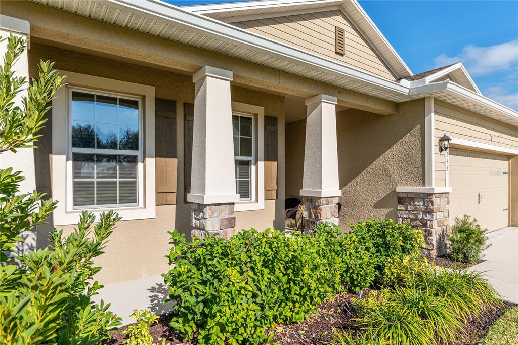 6243 Southwest 89th St Road Ocala, FL 34476 - Photo 5 of 57 front view of the house with a large window and potted plants