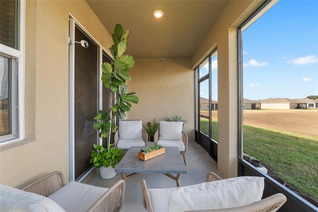 6243 Southwest 89th St Road Ocala, FL 34476 - Photo 51 of 57 a view of balcony with furniture and garden
