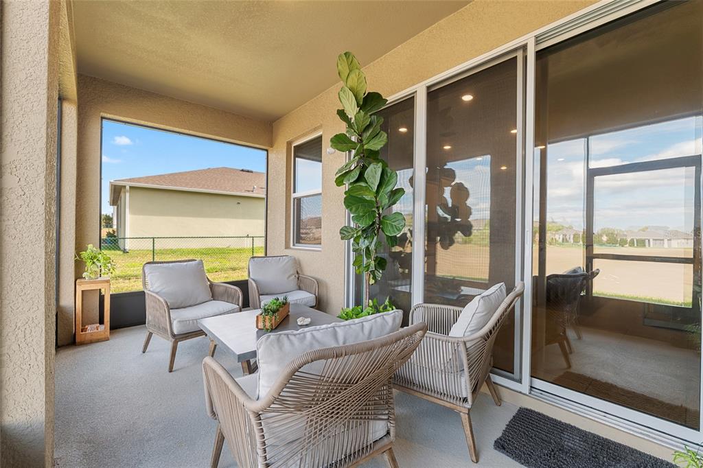 6243 Southwest 89th St Road Ocala, FL 34476 - Photo 54 of 57 a dining room with furniture and a floor to ceiling window