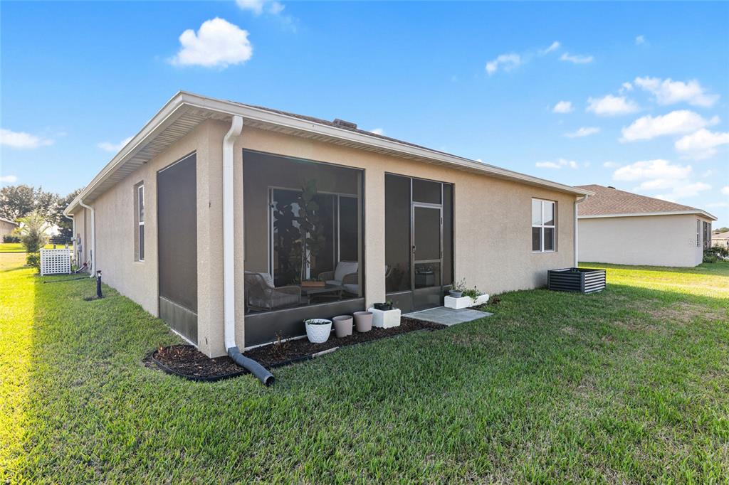 6243 Southwest 89th St Road Ocala, FL 34476 - Photo 55 of 57 a view of a backyard with table and chairs and garden