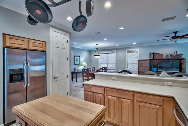 a kitchen with stainless steel appliances granite countertop a sink and refrigerator