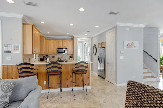 a view of a kitchen with furniture and refrigerator
