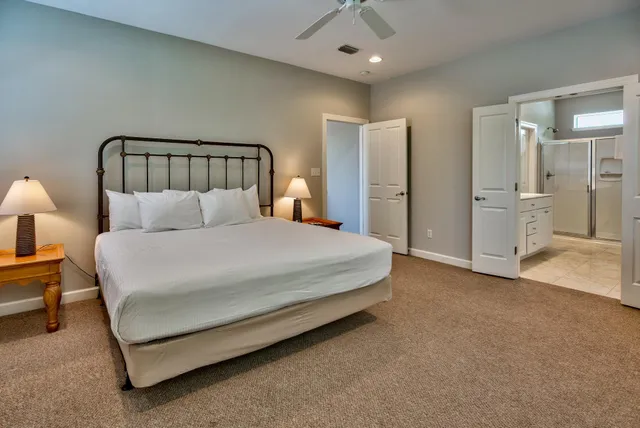 a spacious bedroom with a bed and a walk in closet