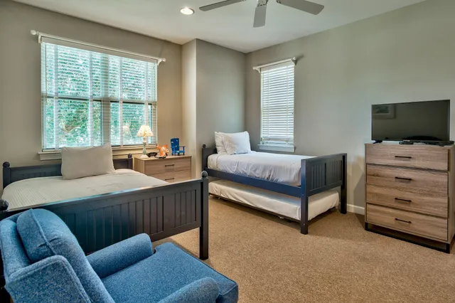 a bedroom with a bed and furniture with a flat tv screen