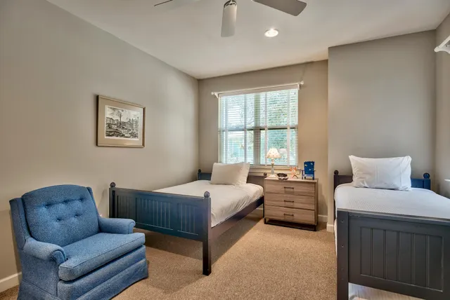 a spacious bedroom with a bed a couch and a window