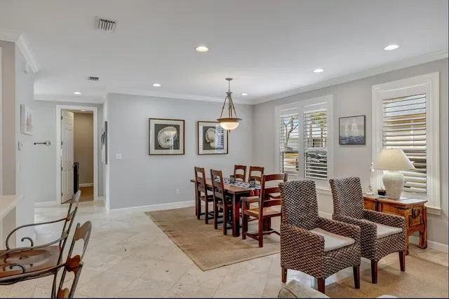 a dining room with furniture window and wooden floor