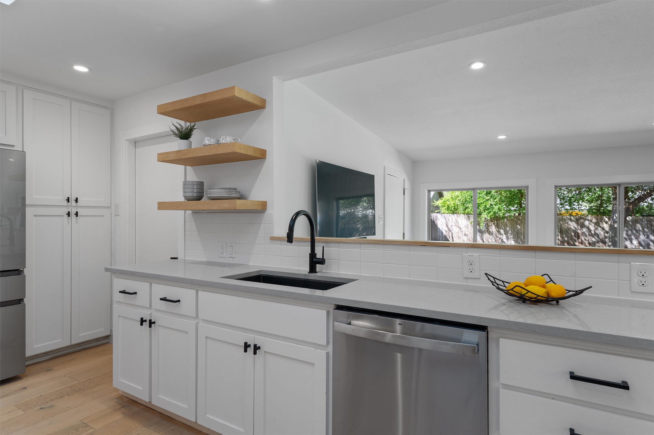 3306 Whiteway Drive Austin, TX 78757 - Photo 11 of 24 a kitchen with a sink a window and cabinets