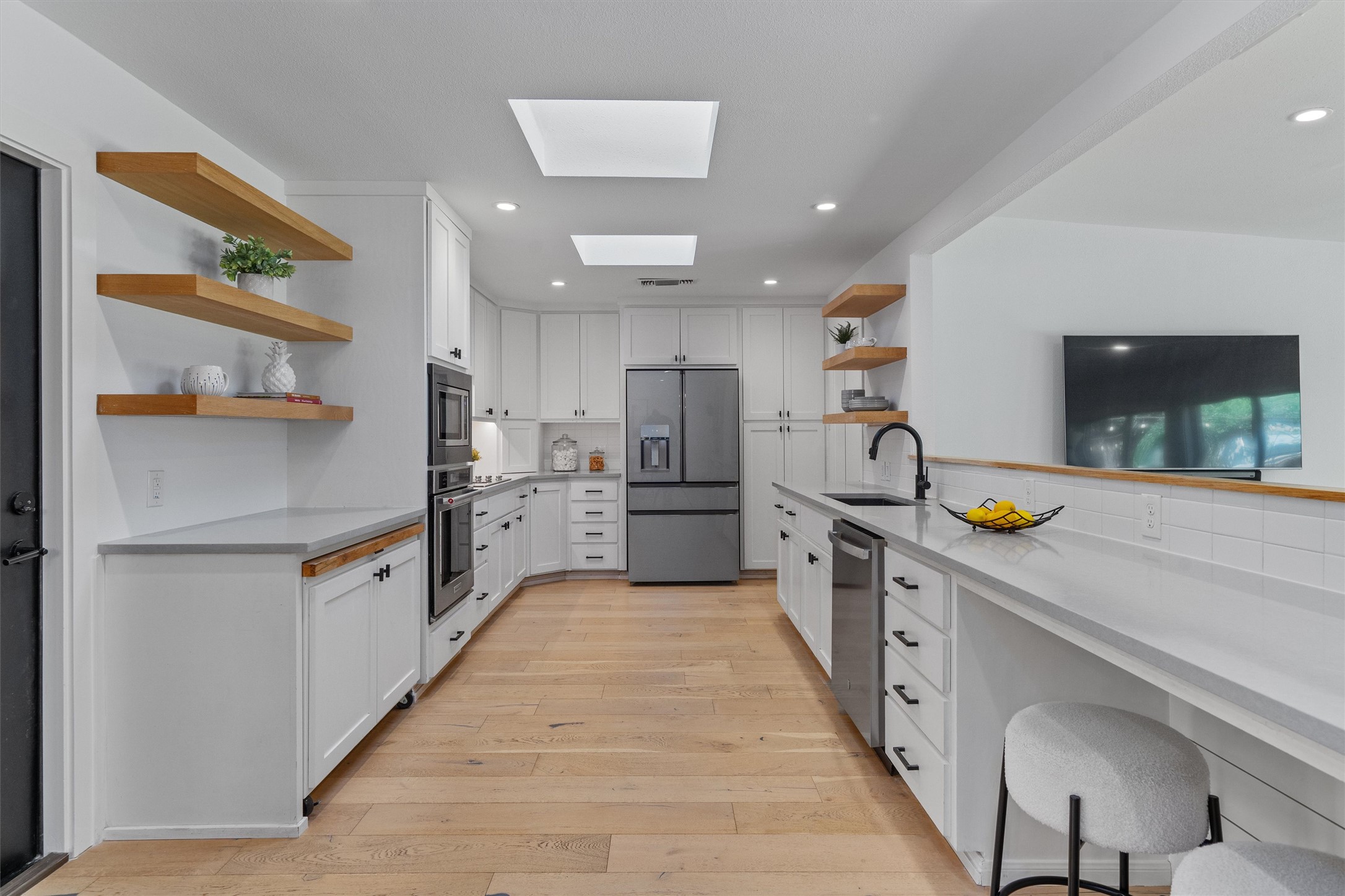 3306 Whiteway Drive Austin, TX 78757 - Photo 2 of 24 a kitchen with stainless steel appliances a refrigerator and a sink