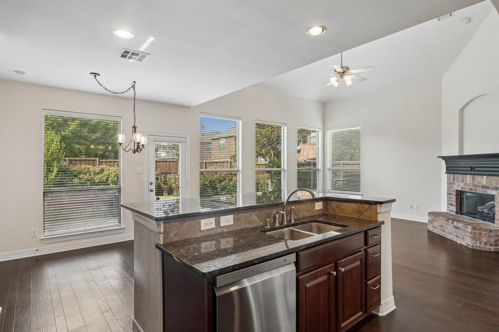 960 Remuda Road Frisco, TX 75033 - Photo 29 of 39 Kitchen island with a double basin sink and stainless steel dishwasher